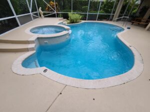 A closeup look of a pool inside a glass dom with a statue in the corner